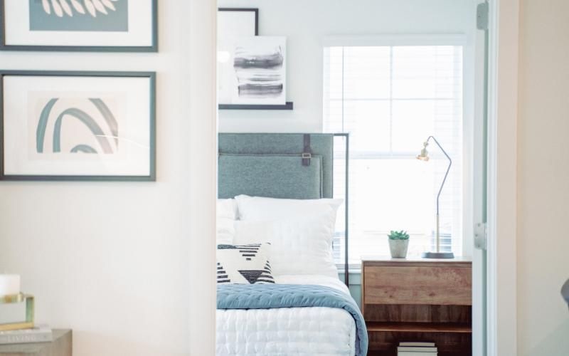 a bedroom with a bed and a window