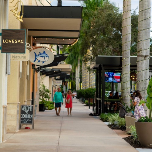 people walking on a sidewalk in the city