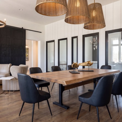 a lounge with a large table and chairs