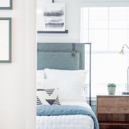 a bedroom with a bed and a window